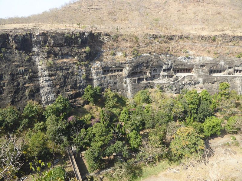 The view here extends downstream as far as Cave 21. The arched window of Cave 26 indicates a prayer hall or chaitya. Flat entrances indicate