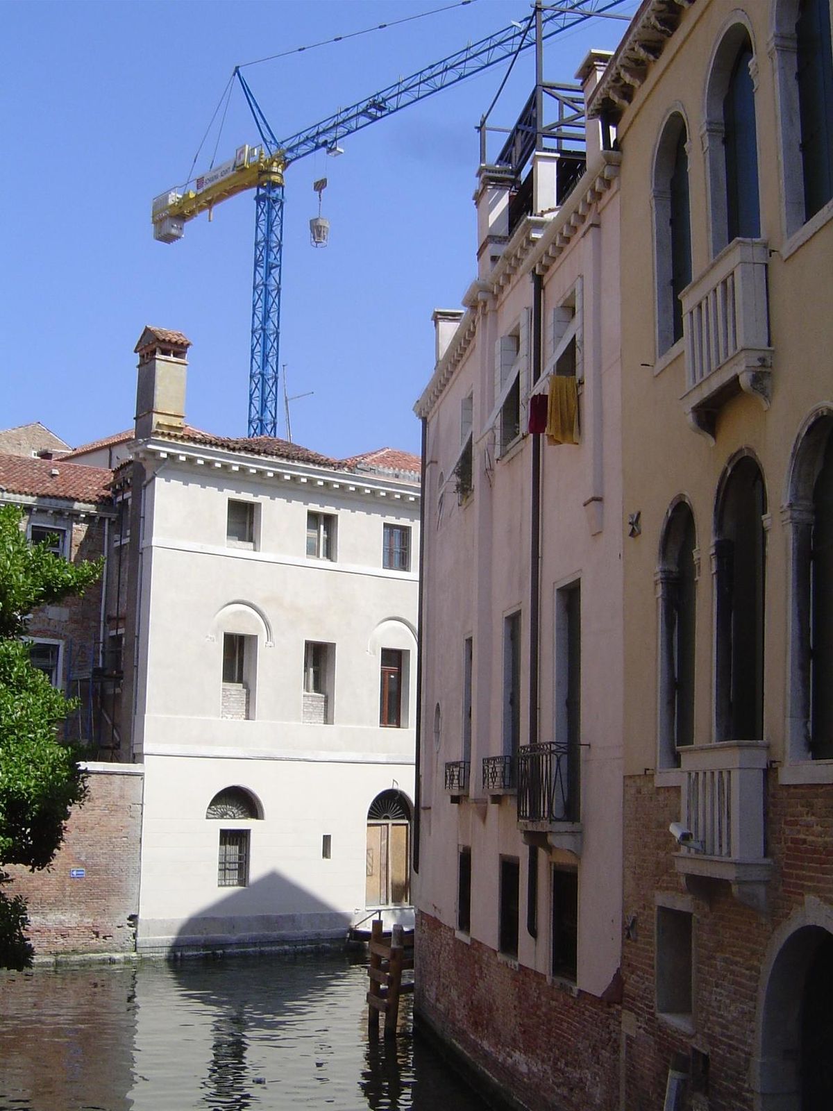 A self-climbing tower crane works to shore up the Church of San Lorenzo.