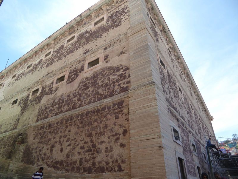 Percy Martin continues: "The Alh ndiga, or Castillo de Granaditas, is a perfectly square, flat-roofed, solid-looking building, not in the le