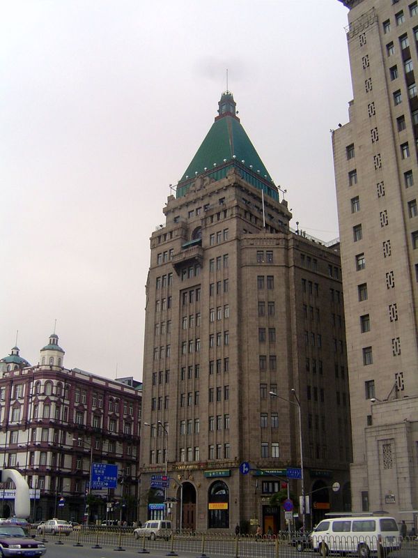 The pyramidal building is the Sassoon House now the Fairmont Peace Hotel, built in 1929 and boasting air-conditioned ballrooms. It was the c