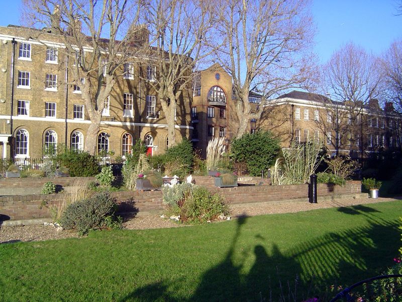 A sunken garden, with another bollard, marks the alignment of the filled entrance lock.