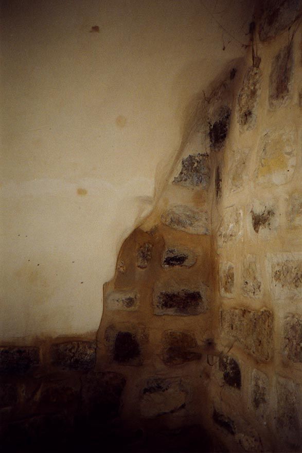 Stone walls and plastered vaults. Electrical lines are sunk in the plaster, but the stone walls are remortared and even dismantled as necess