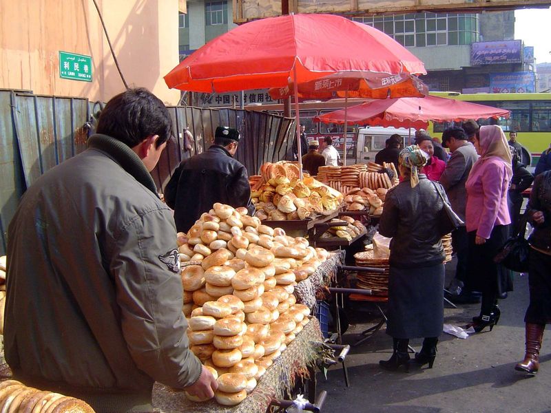 Uighurs are busy outside, here with a variety of breads.