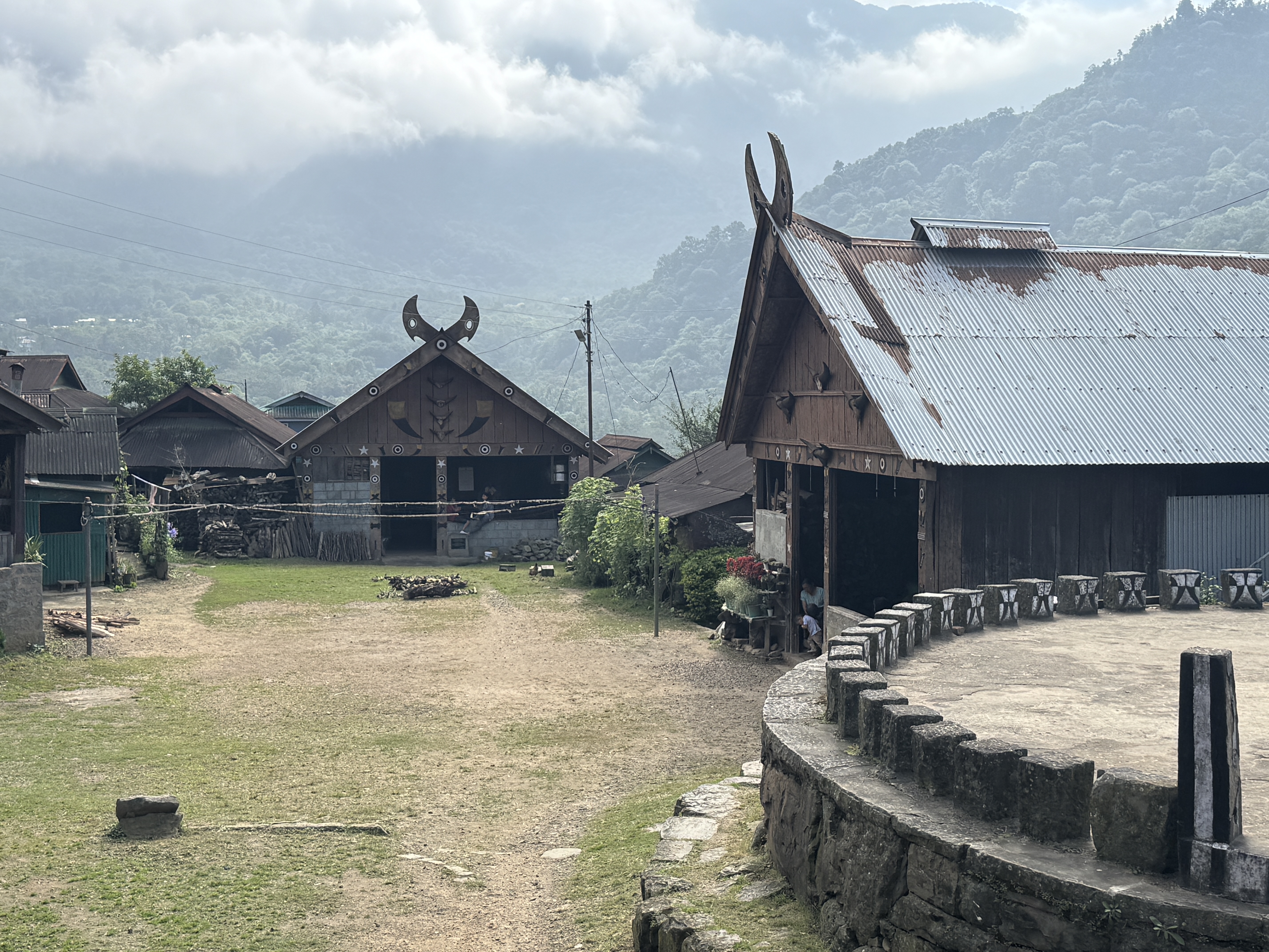 Khonoma hangs on to traditions at the same time as it abandons them.  Here's a stone meeting place and two traditional meeting halls.