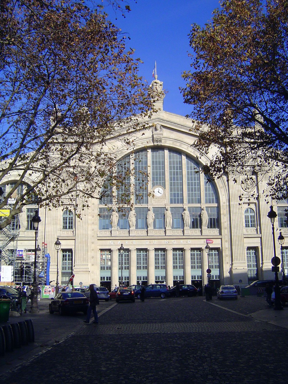 He did it with a huge gable following the curve of the train shed behind it. Still, it's trimmed with Ionic pilasters and statues personifyi