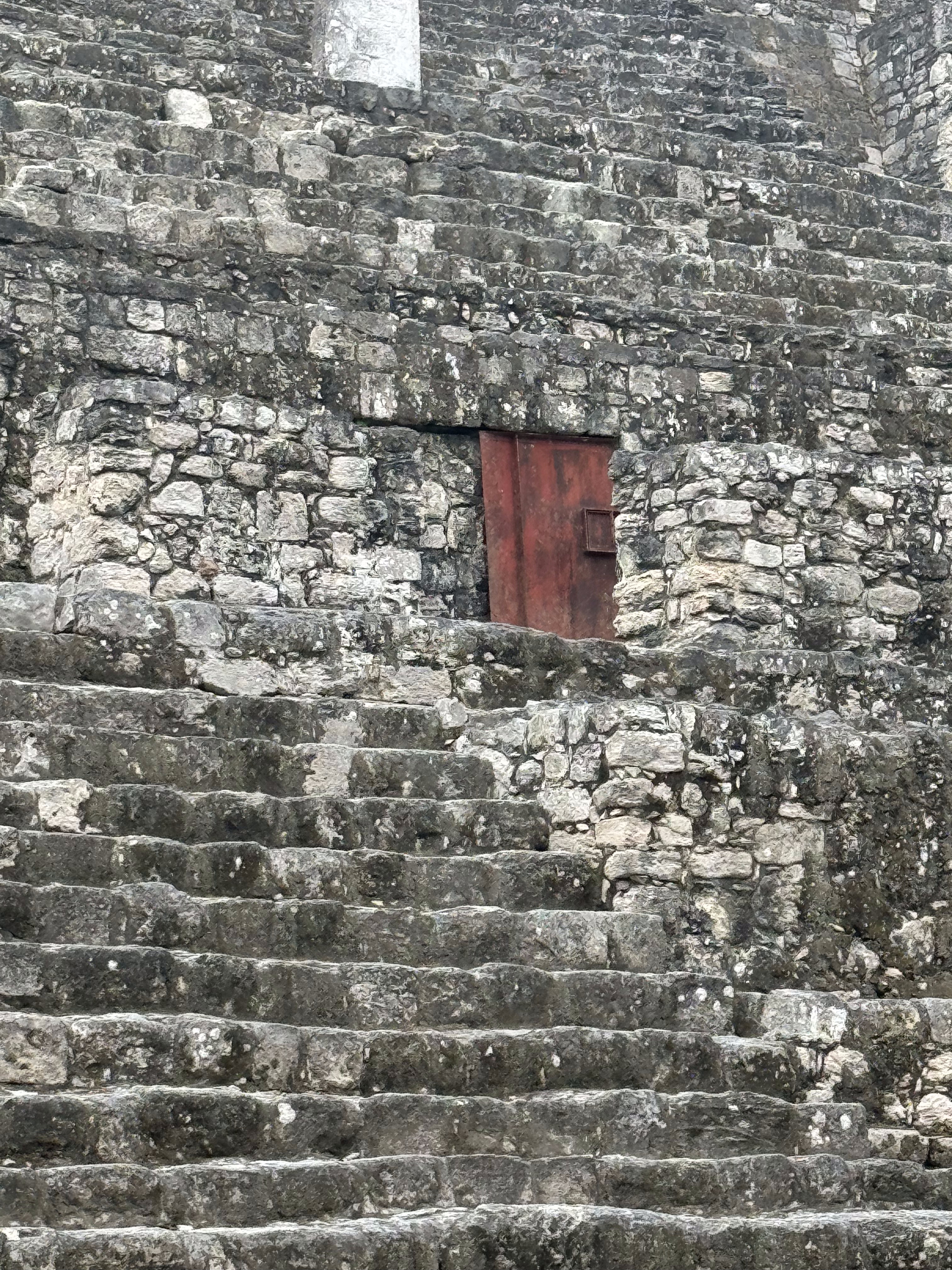 I'm not sure where this door leads, but the mountain includes the remains of a king buried along with two sacrificial victims, a young woman