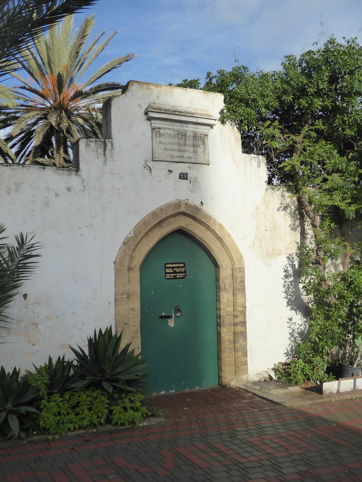 How's this for atmosphere? The sign says that the door opens at nine, but no luck. The plaque above says that the cemetery was "dedicated to