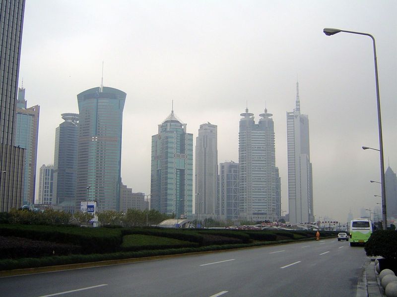 A cluster of Lujiazui towers. The arc-topped building is the World Finance Tower. To the right of it is the China Merchants Building. The do
