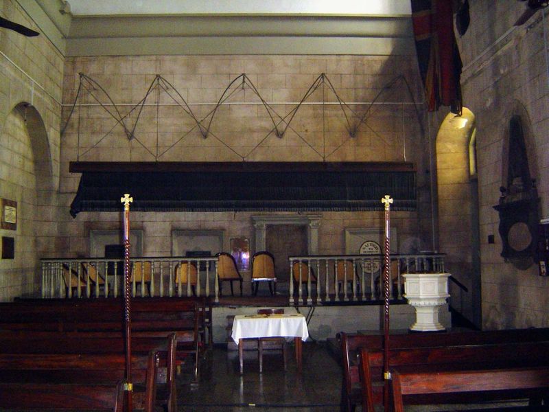At the rear of the nave, a massive black punkah can stir the heavy air.