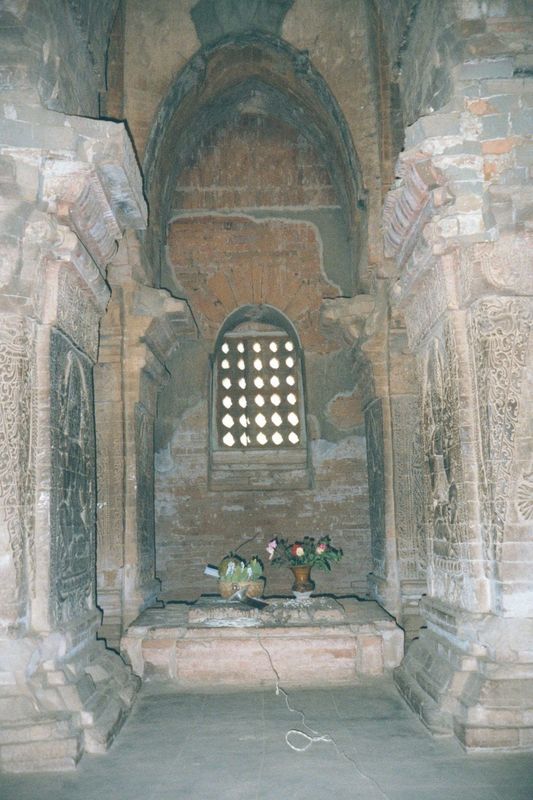 Inside, the dark shrine is a cubic room almost filled with four massive piers. They're too big simply to support the roof and tower. Instead