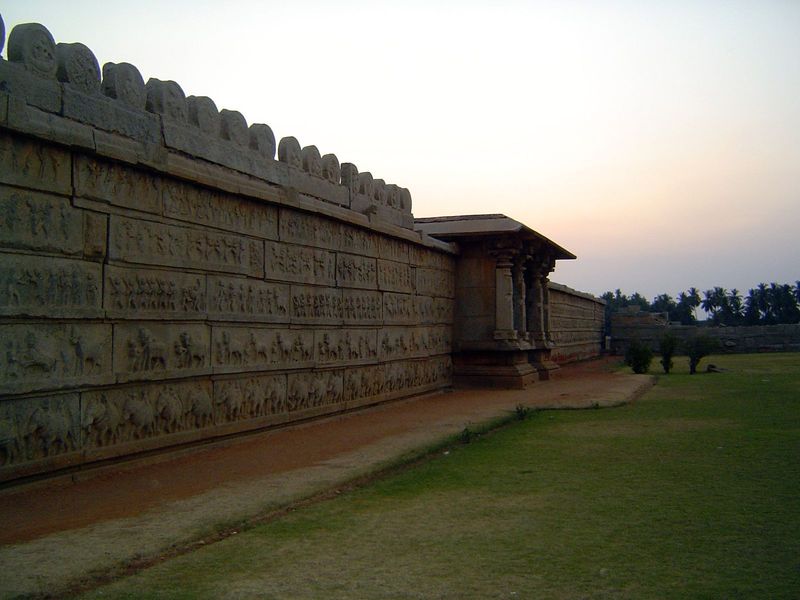 The outside wall of the temple faces the lamp tower and is covered with images of processions.