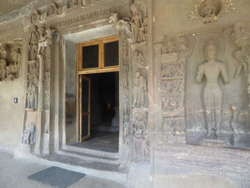 The large figure on the right is an intrusion, added in the troubled times after the death of Harisena. The figure is Avalokiteshvara, and t