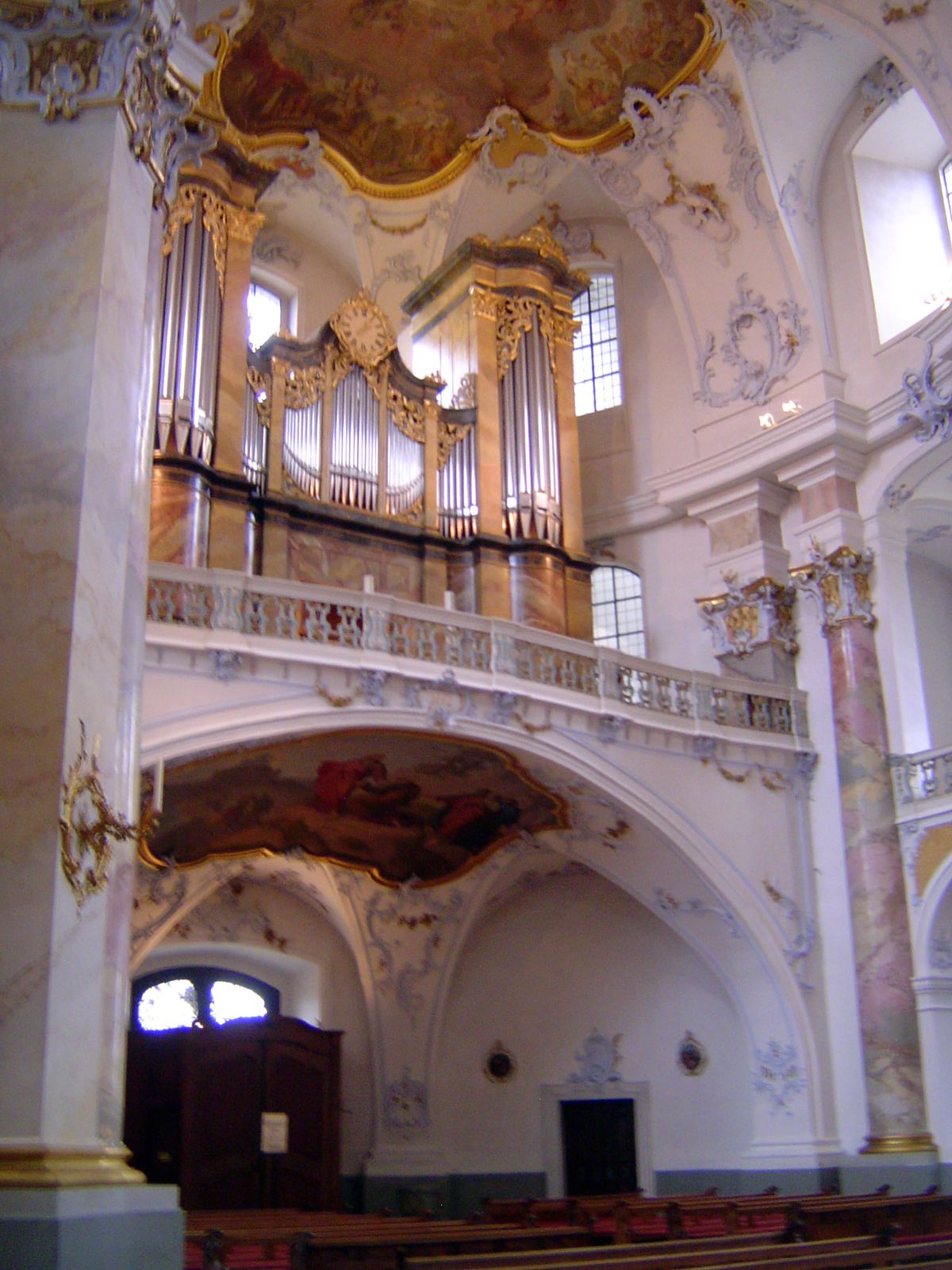 He has in mind, at least in part, the complex curvature of the ceiling.