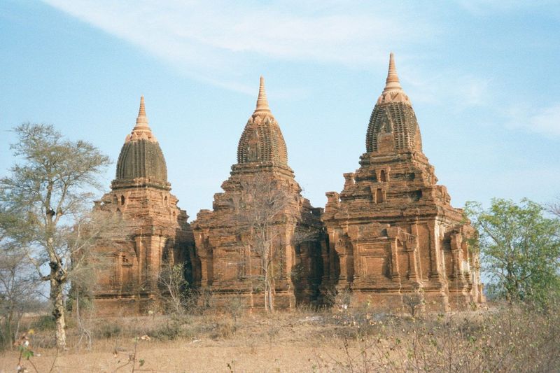 Close by, Paya-thon-zu, "three temples," also from late days. The rooms are dark but remarkable for their paintings.