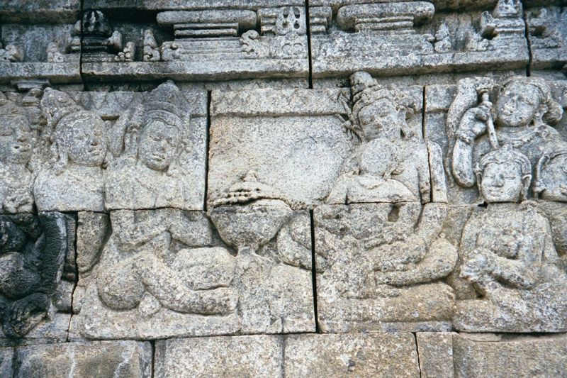 Wise men come to honor the child, shown in his father's lap.