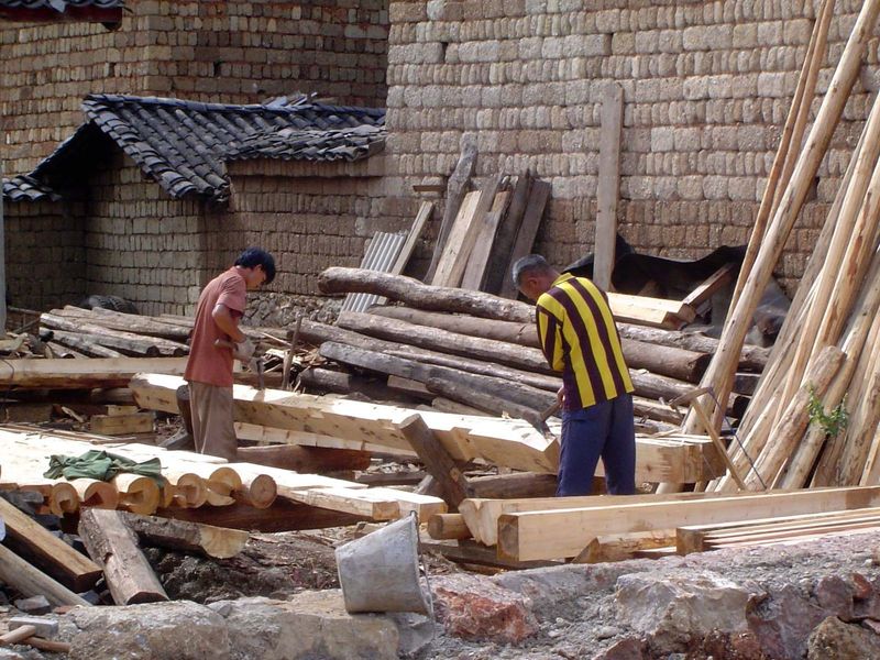 Longcheng is grappling with the same choice of tradition and change.\  Here, carpenters still trim planks with adzes.