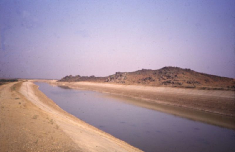 Farther downstream.
