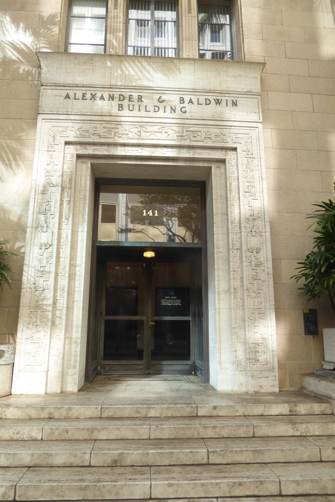 The architect was C.W. Dickey 1871-1942, an MIT graduate whose career was spent in Honolulu. The material is terracotta.