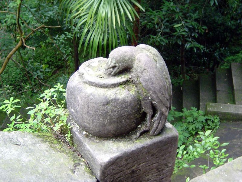 Along the path: a stone crow.