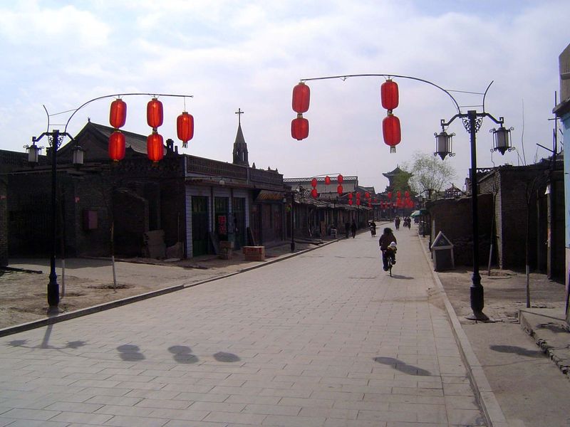 Farther east, commercial development drops off. In the distance, the Ting Yu tower over the east gate. You see the church; we'll circle back