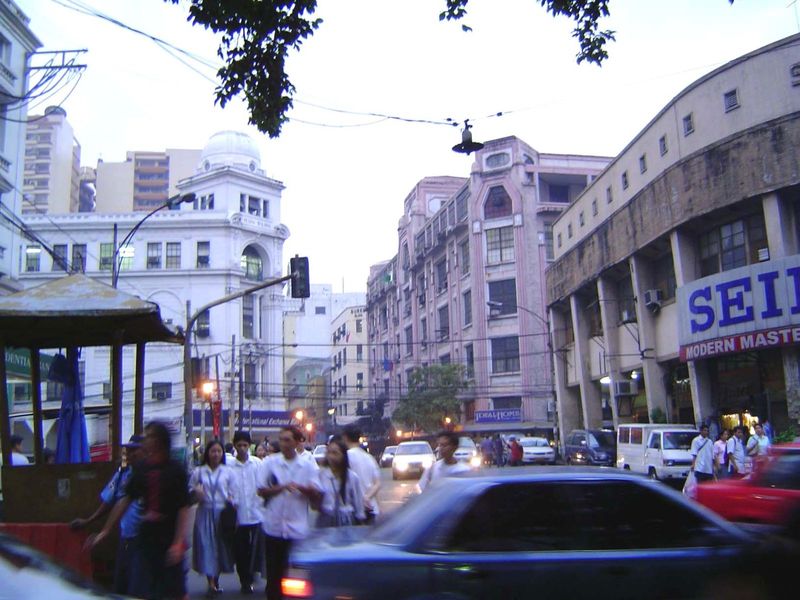 Farther along the Escolta. The two prominent and still very active office buildings are the Regina Building on the left and the Perez-Samani