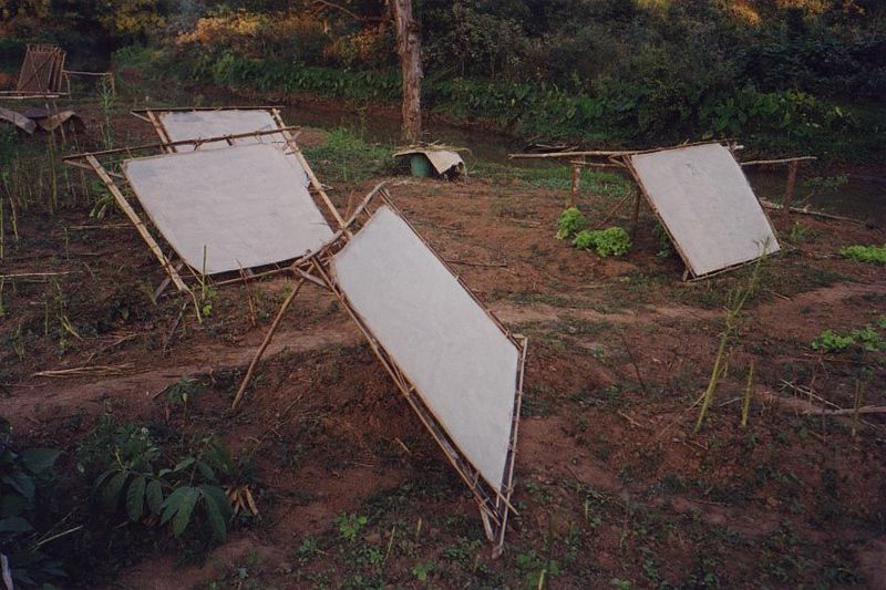 Nearby, coarse rice paper dries.