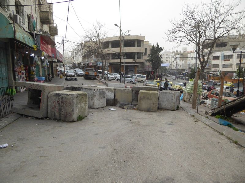 Cross through a checkpoint with your passport so you can return, and you come to the the part of Hebron that still has people.