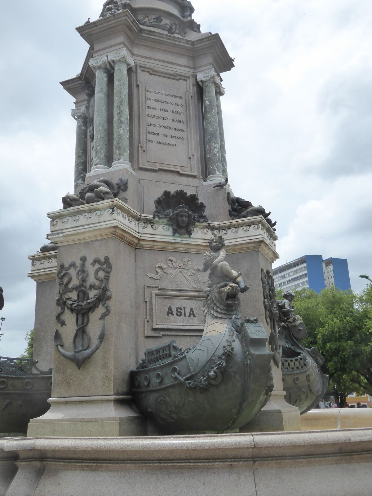 The cherub on Asia's boat sits on a lion and holds a bowl of...what? Fruit? Just below the lion there's an Islamic crescent. The plaque stat