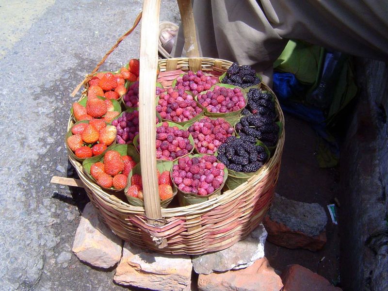 Baskets of strawberries and possibly raspberries and mulberries.
