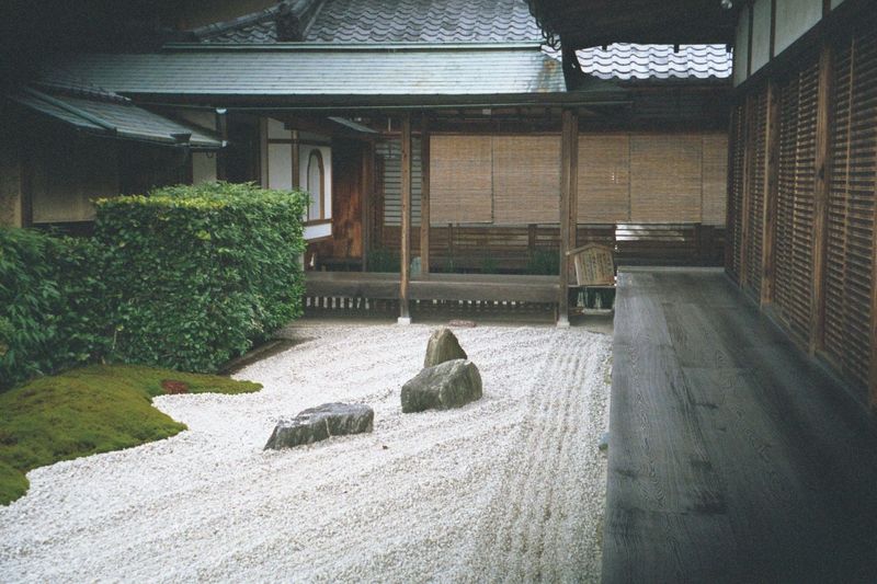 Inside a dry garden karesansui, literally "lacking mountain or water", with artfully chosen stones, meticulously raked gravel, and bordering