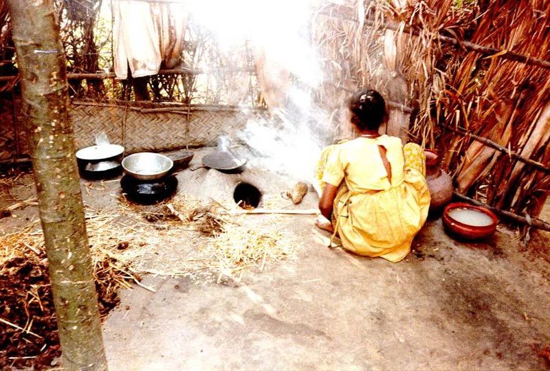 In a corner of the same compound, a girl cooks.