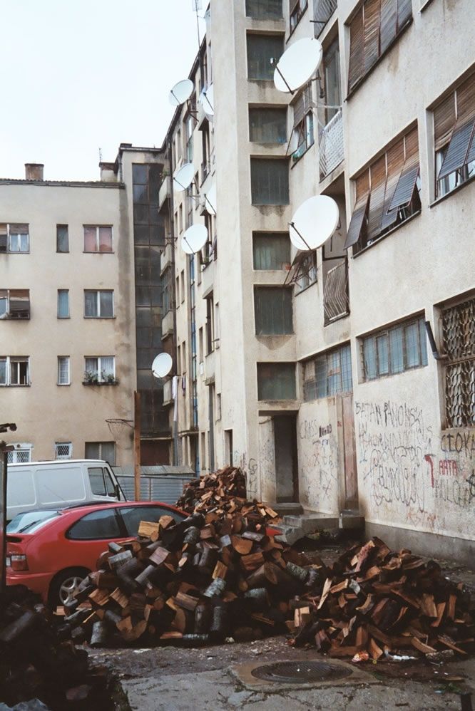 The apartments look modern, but they lack central heating. Hence the wood pile, which keeps one room in each apartment marginally warm.