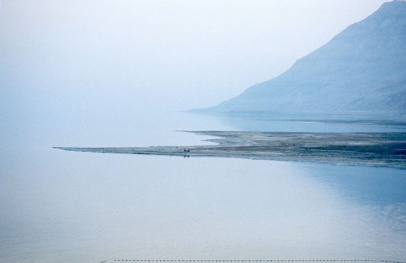 Visibility-clouding mists are common on the Dead Sea. The emerging flats are an indicator of the sea's declining water level, a result of hi