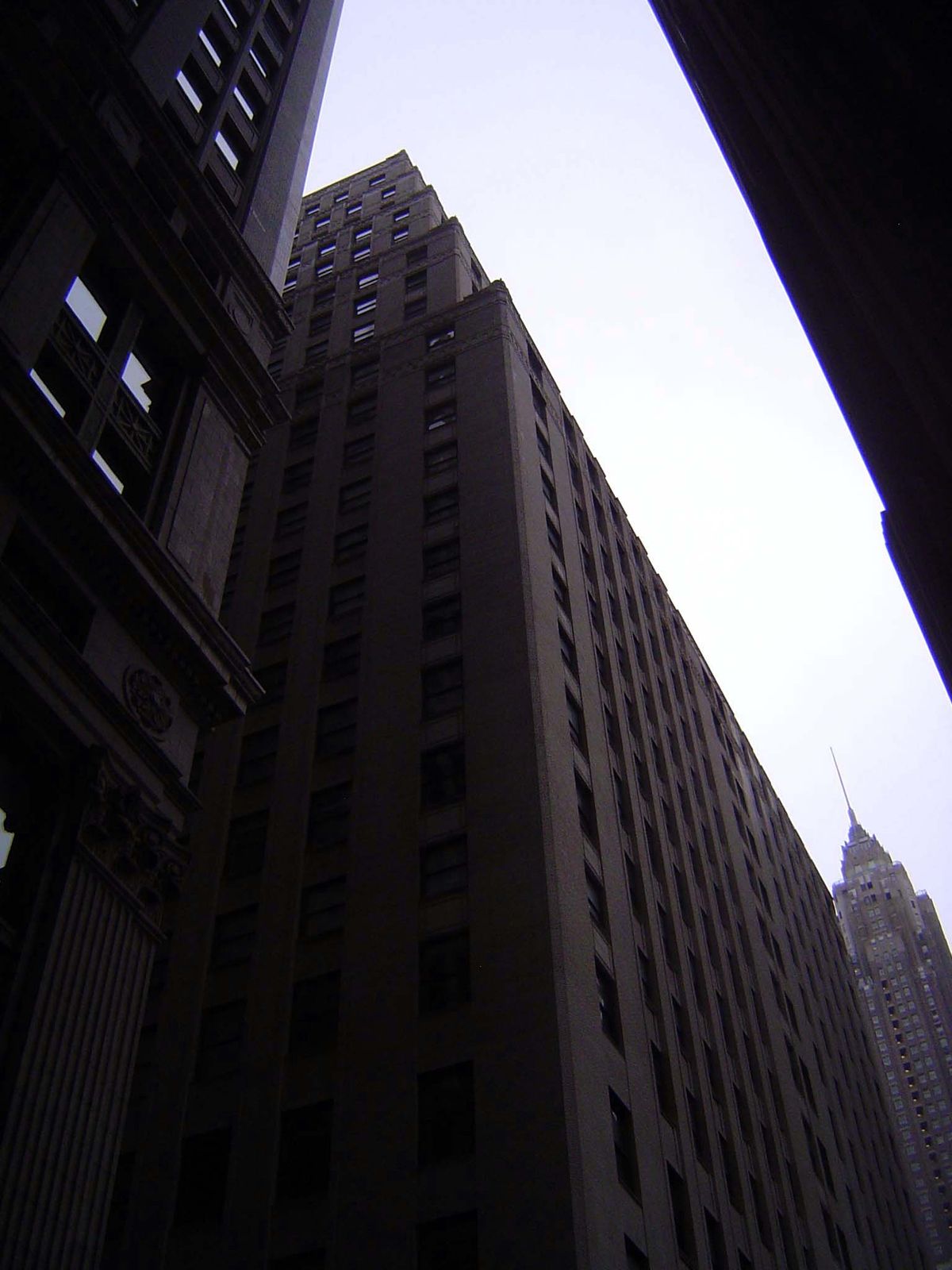 Behind Federal Hall, the old Chase Manhattan Bank at 20 Pine does away with most of the classical dressing. It also has lost its namesake te