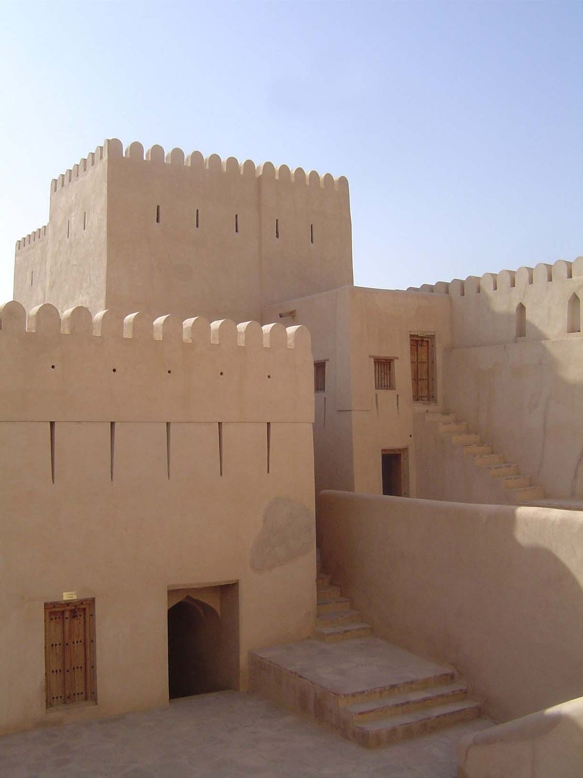 The handsome color comes from sarooj, a nearly forgotten Omani building material. Oasis soil is formed into bricks, which are stacked, cover
