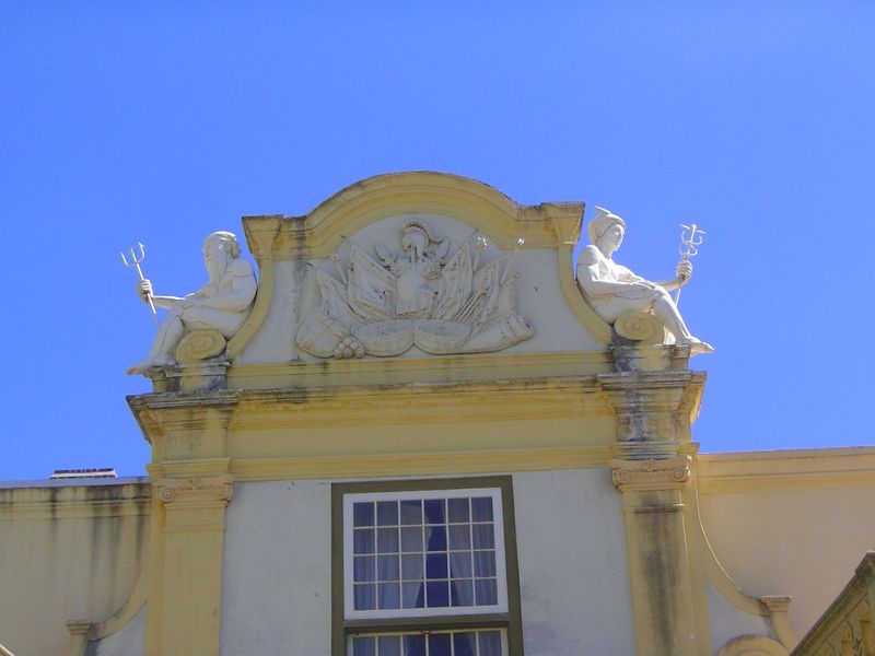 The flags are military trophies. Neptune and Mercury evidently take a break, not something you'd think gods needed.