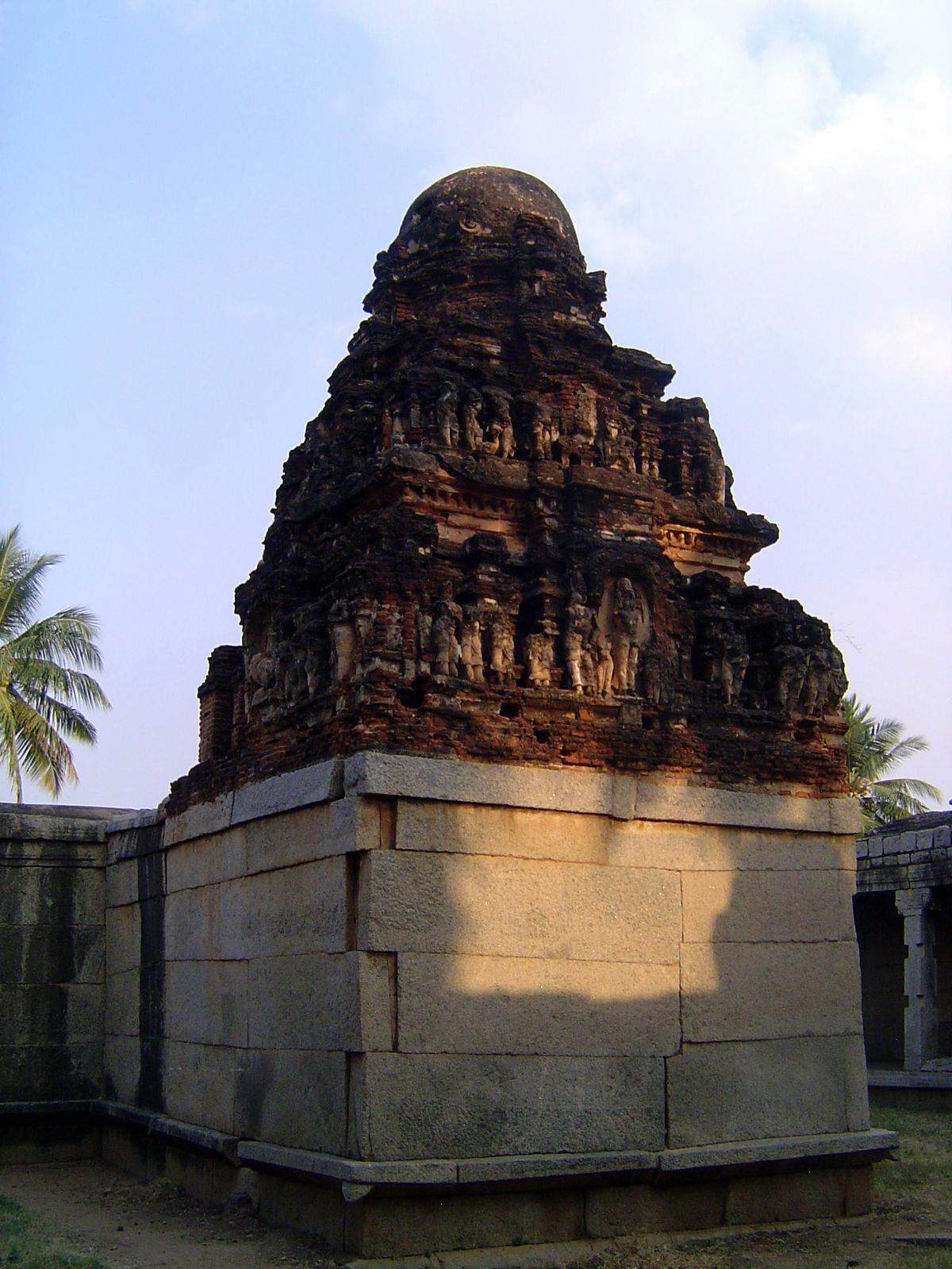 The same irrigation channel passes this, the Chandikesvara Temple, built in the locally standard way with a granite base and brick-and-plast