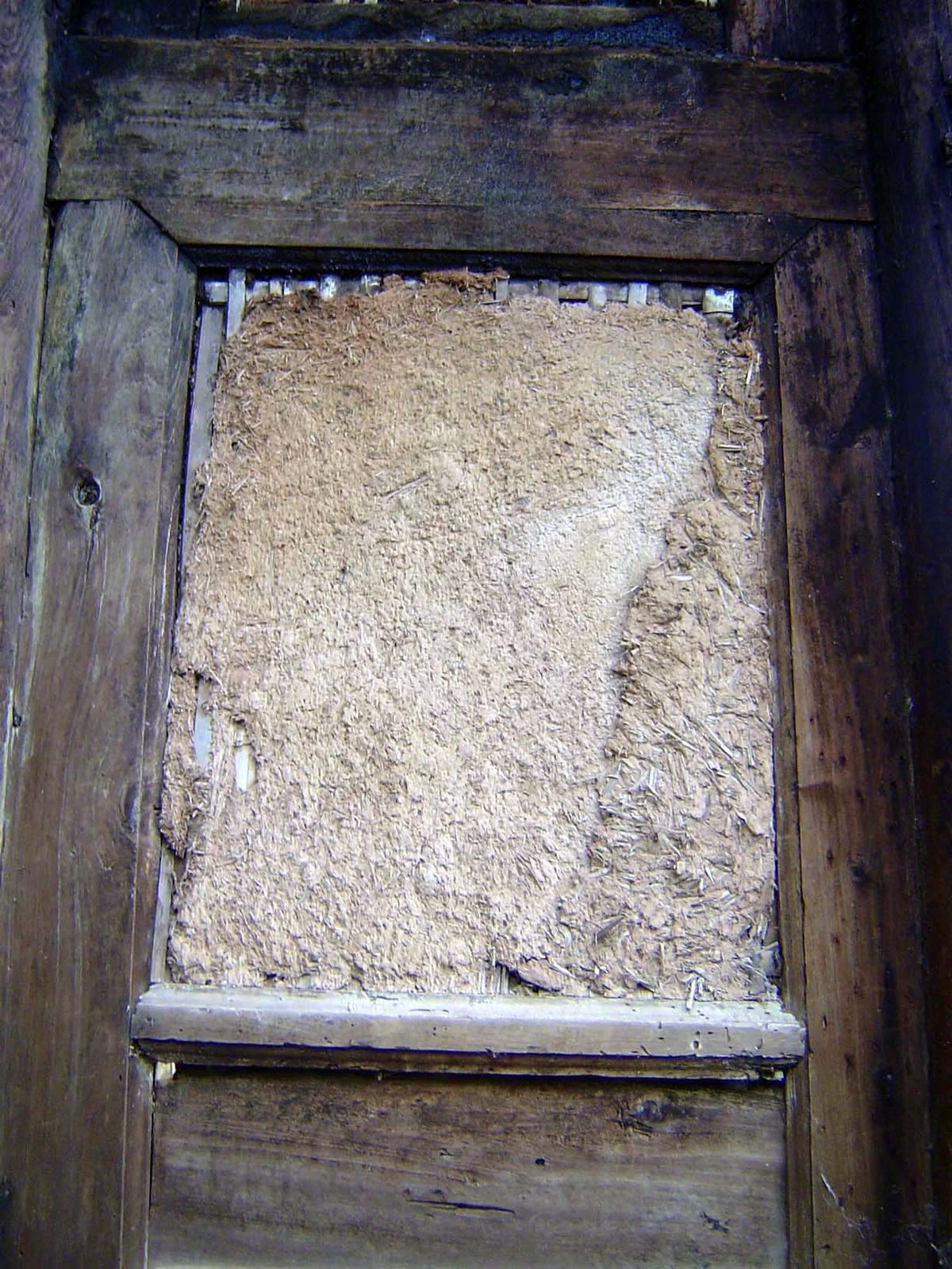 With the conversion of a house to a barn, a screen is plastered over.