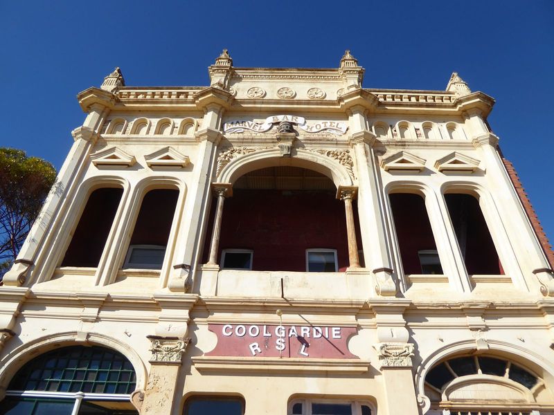 It's stucco over brick, with blind arches in the parapet, an arcaded veranda, and free floating pediments between.