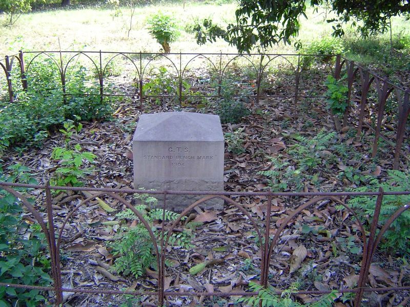 Outside, a quiet benchmark for the Great Trigonometrical Survey of India.