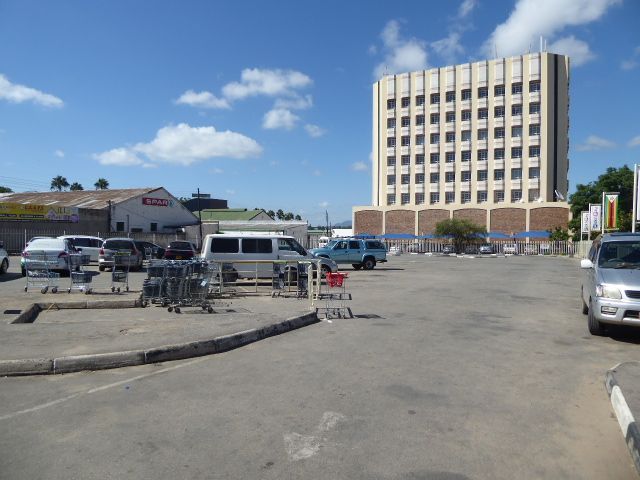 The town's one attempt at a highrise office building shares parking with a SPAR supermarket.
