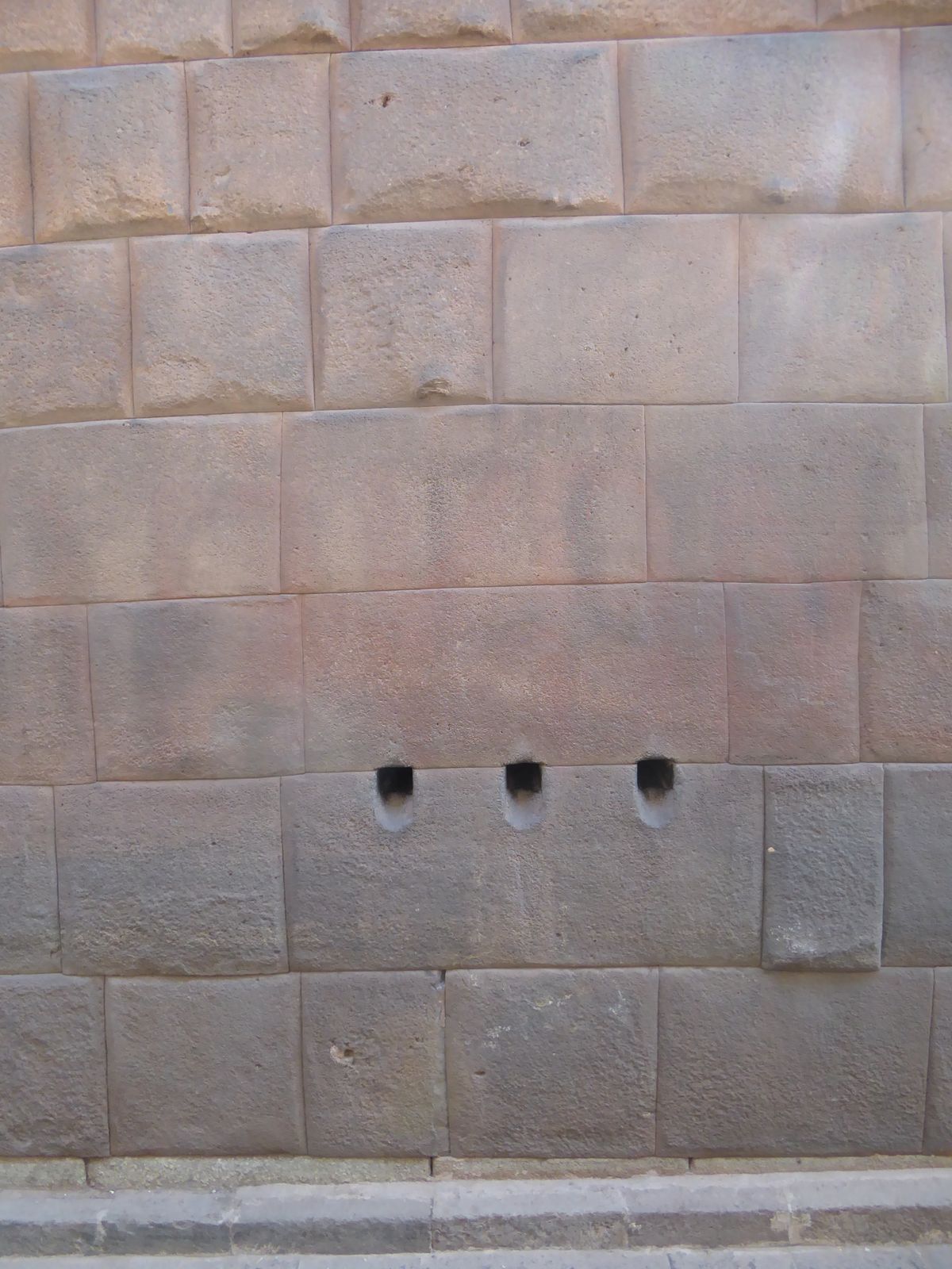 It's one of three that penetrate the wall, which is a single block thick. Here, on the outside of the building, is the other end of those ho