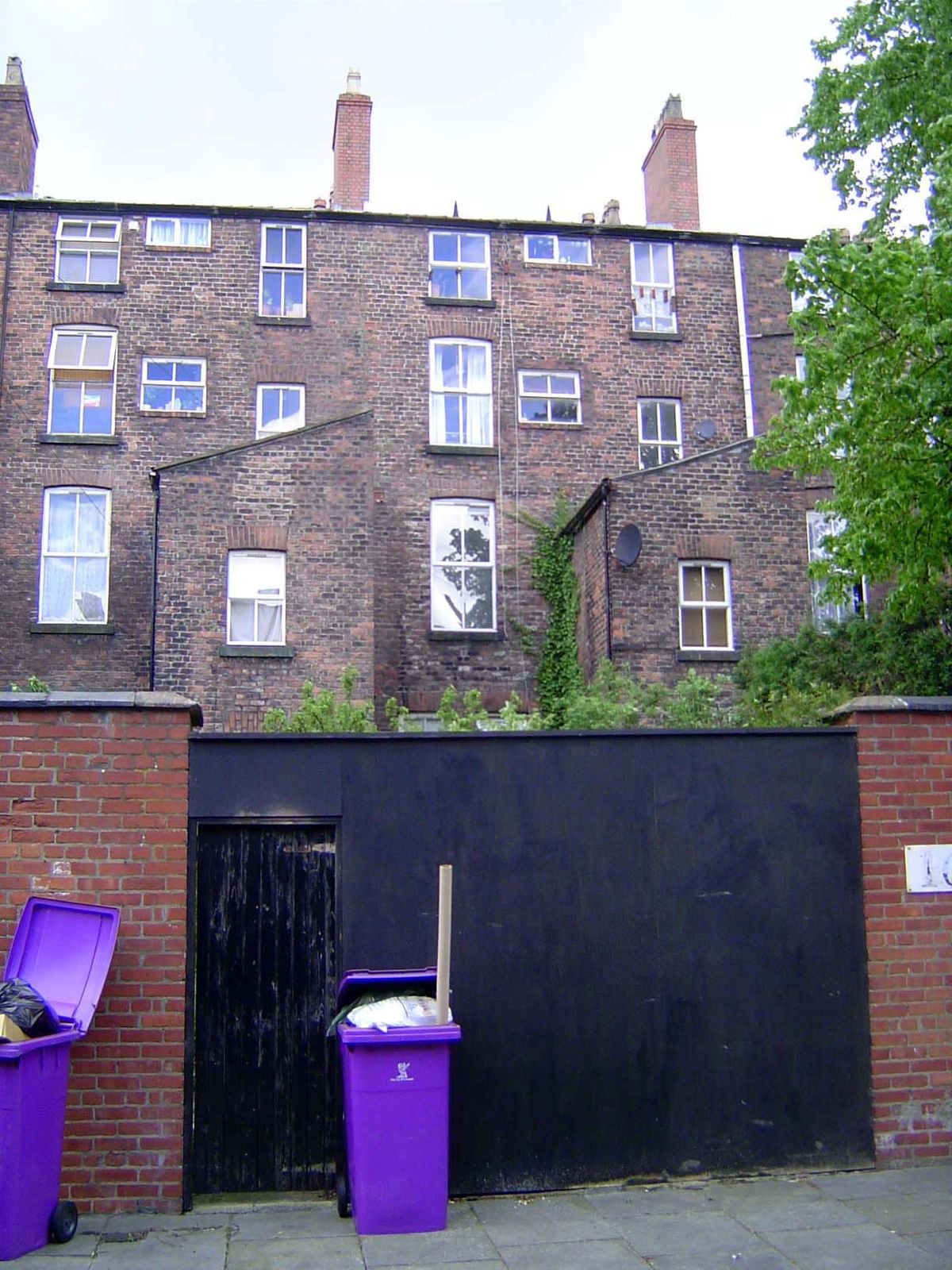 From the back, Gambier Terrace reveals the underlying structural brick, along with protruding kitchens.