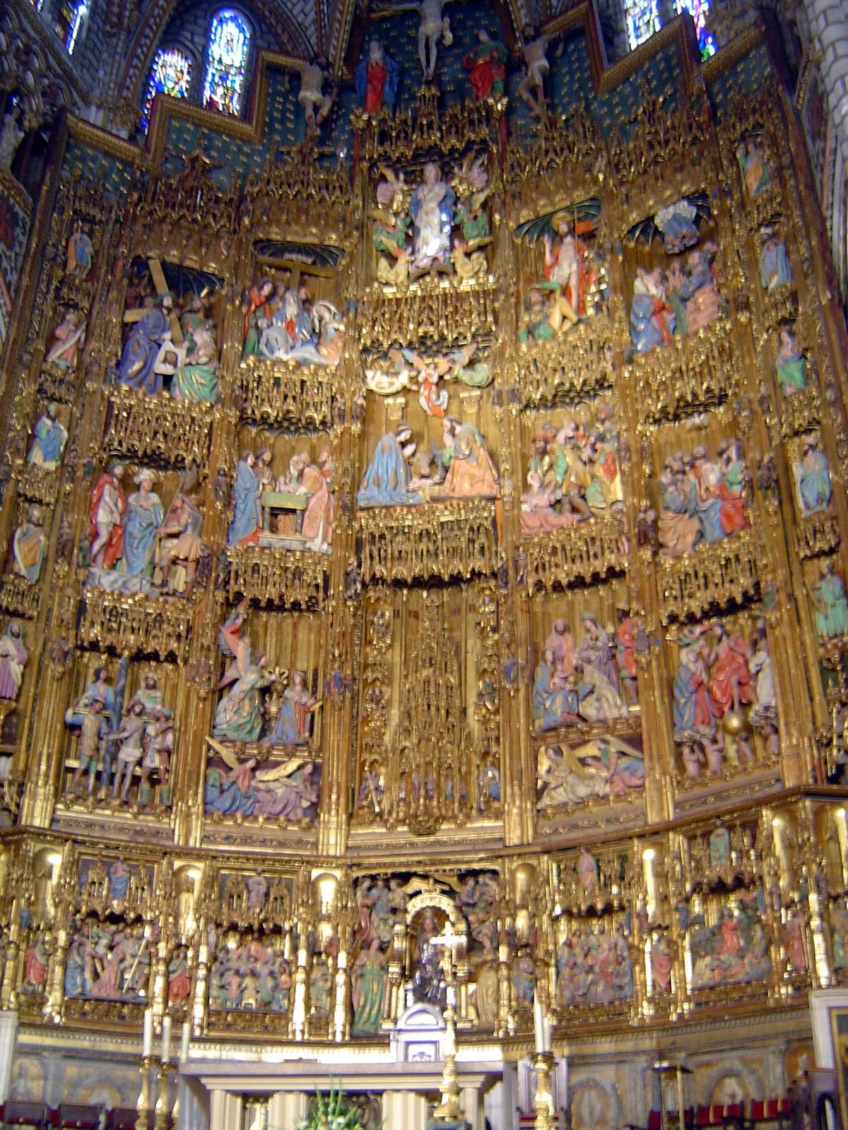The central panels show a Virgin and Child at the base, above it a tabernacle, then a Nativity scene, then the Ascension and, at the top, Ch