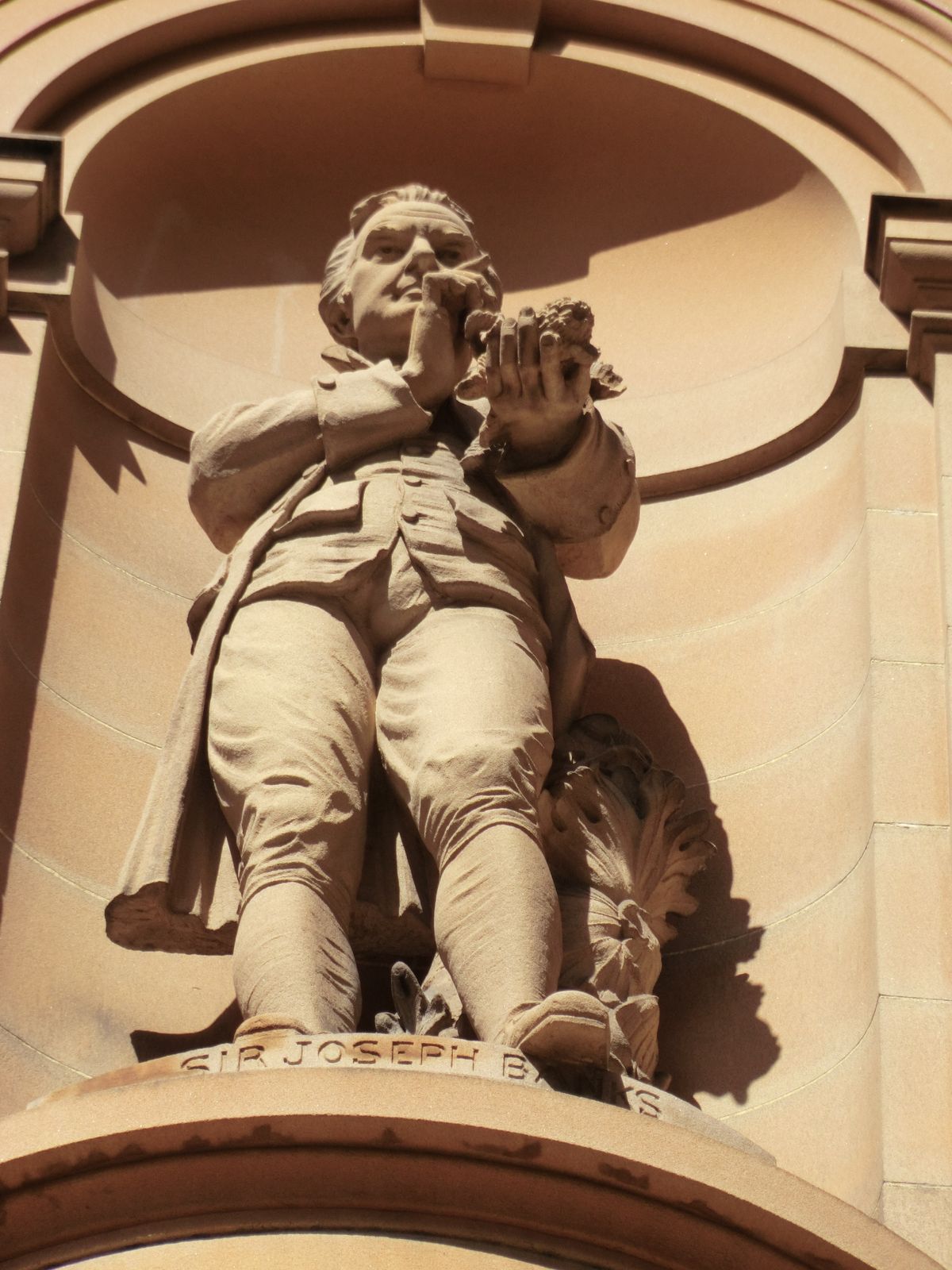 Heaven knows what he's holding. He was president of the Royal Society for 41 years, however, so it must be important.
