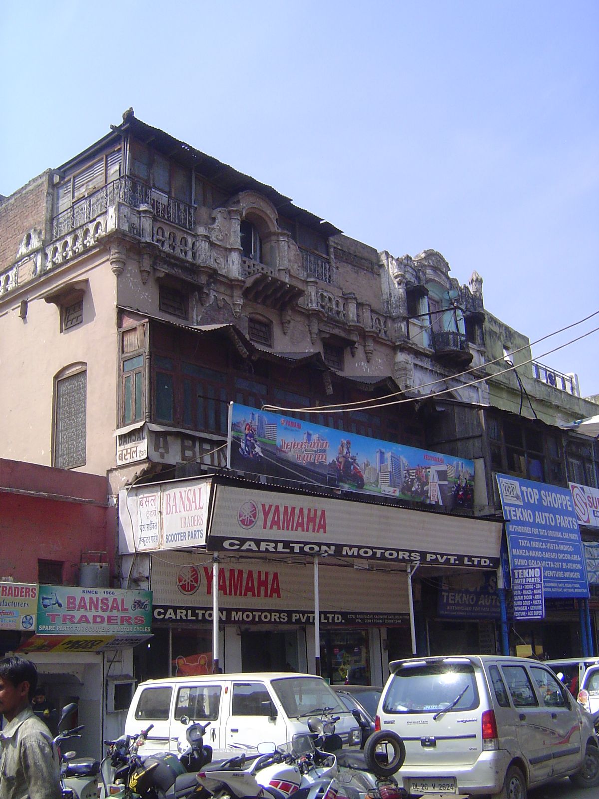 Perhaps a century old, the building has gained a top floor behind the parapet.