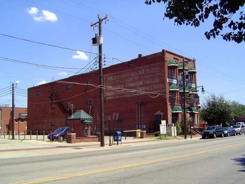 Some old factory buildings survive, too, including the Oklahoma Furniture Manufacturing Company, which was built in 1904. The green awnings 