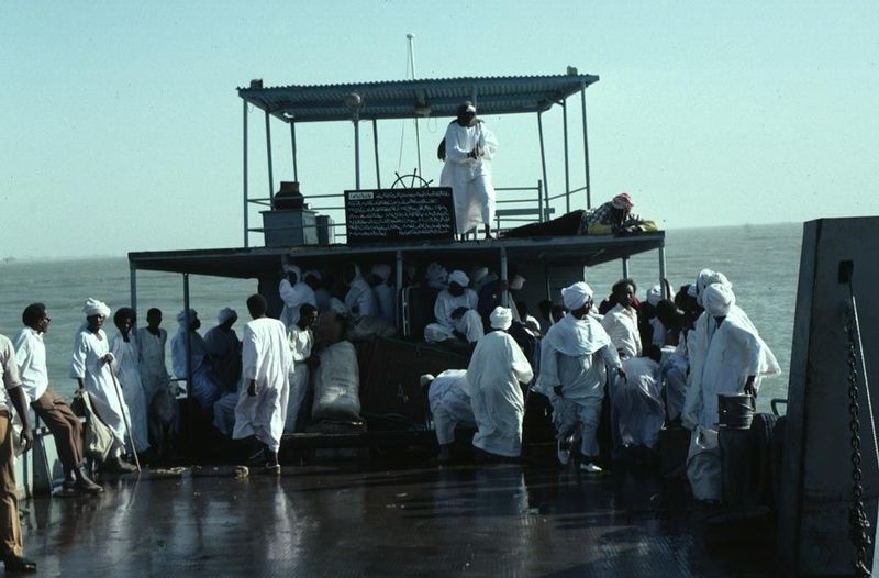 A ferry crosses the broad reservoir formed on the White Nile by the Jebel Aulia Dam, upstream from Khartoum but built by and for Egypt. The 