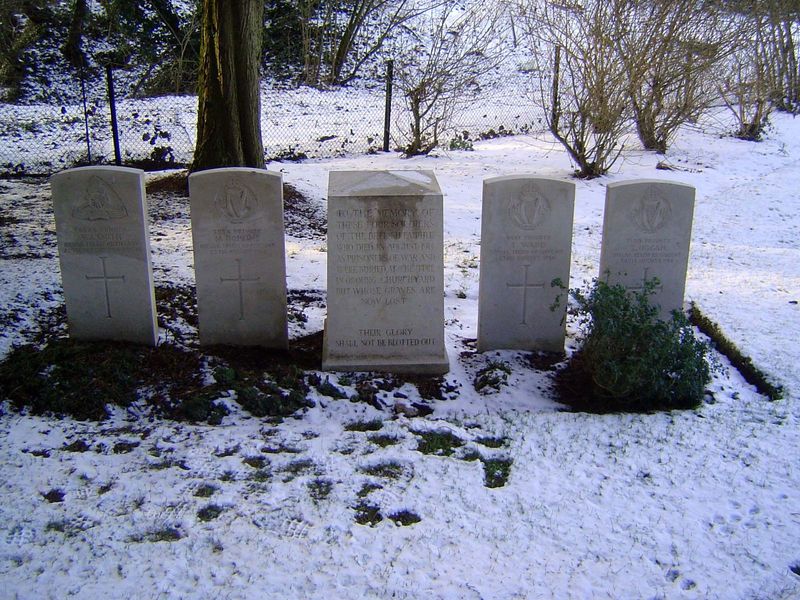 A later cluster of four graves and a monument.