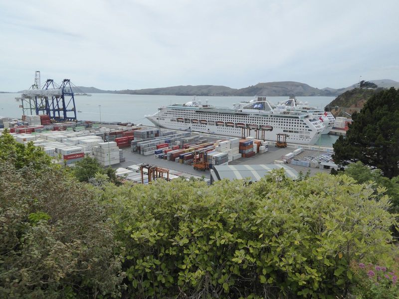 The filled land is now a container port. The cruise ships may be a surprise, but the Queen Elizabeth 2 docked here in 1992, and fleets of bu